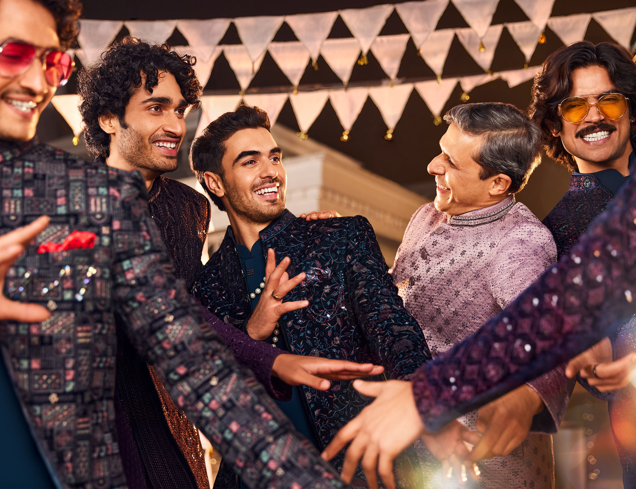 Men in colorful kurtas enjoying the engagement ceremony